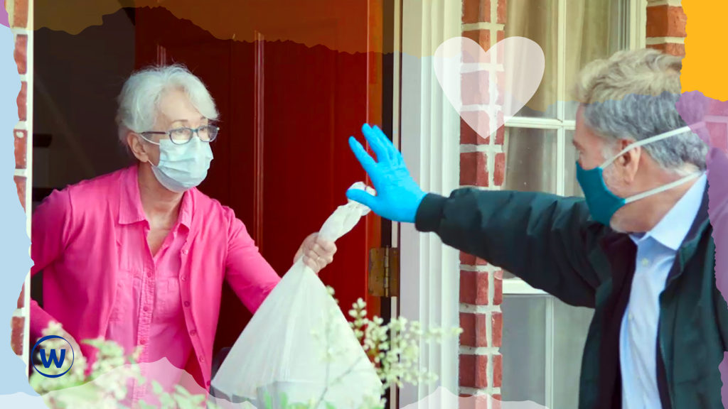 Lady wearing a face mask receiving bag of goods at her front door, from a man wearing a face mask and gloves