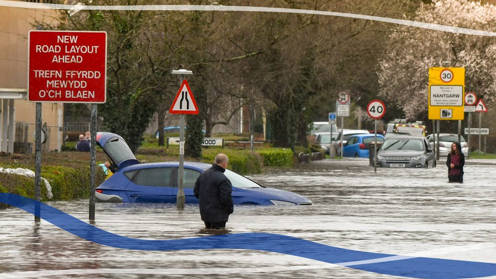 Person walking through a flooded street